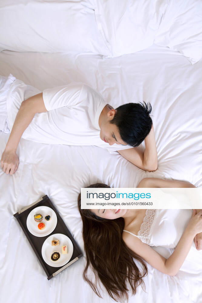 A couple enjoying life in a hotel room 55295084014470400