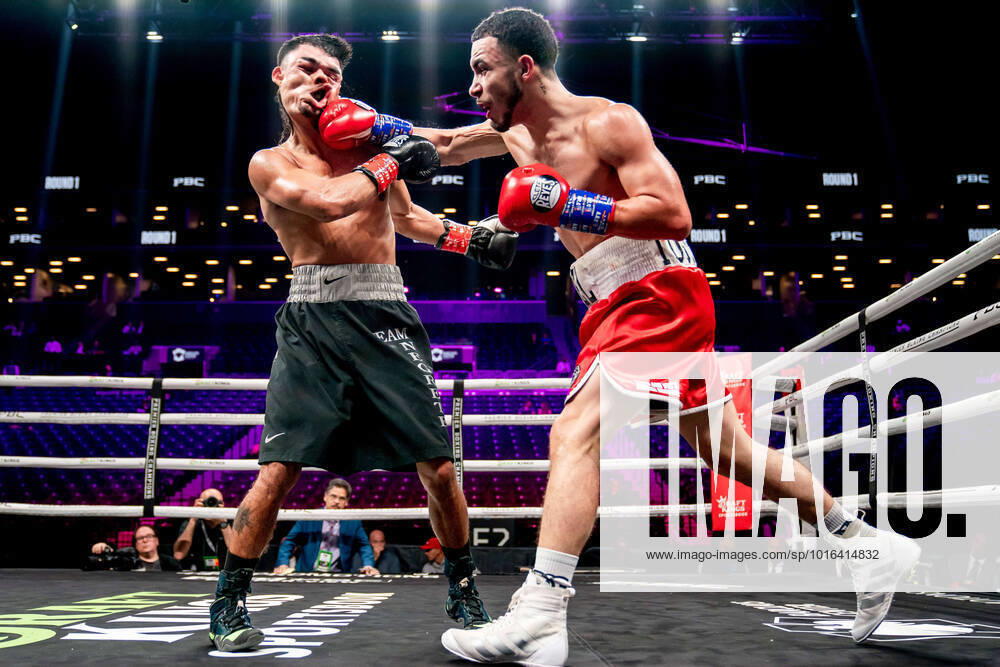 MIGUEL ROMAN (red trunks) and JOSE NEGRETE battle in a super bantamweight bout at the Barclays Center in Brooklyn, New York. Brooklyn USA - ZUMAp109 20221015_zaf_p109_001