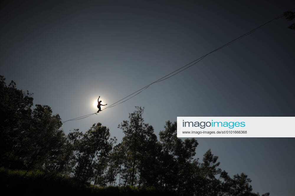 Bilder des Jahres 2020, Entertainment 06 Juni Entertainment Themen der Woche KW24 (200614) -- BEIJING, June 14, 2020 -- Extreme sport athlete Andi Ardi wearing a face mask walks on a tightrope at Kali Talang Merapi in Klaten, Central Java, Indonesia, June 13, 2020. Ardi performed extreme sport by wearing a face mask as part of the campaign of following health protocol in tourism site. (Photo by Xinhua) XINHUA PHOTOS OF THE DAY Supriyanto
