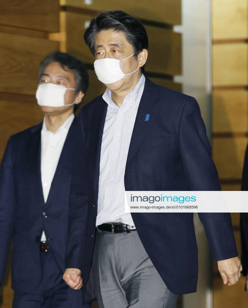 Japan PM Abe Japanese Prime Minister Shinzo Abe leaves his office in Tokyo on June 14, 2020, wearing a face mask amid continuing worries over the novel coronavirus.