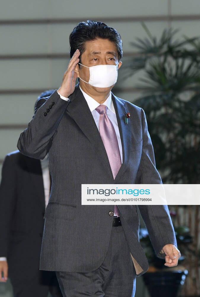 Japan PM Abe Japanese Prime Minister Shinzo Abe arrives at his office in Tokyo on June 24, 2020, wearing a face mask amid concerns over a possible second wave of coronavirus infections in the country.