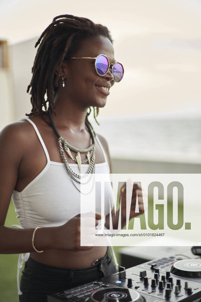 Portrait of happy DJane at mixing board dancing model released Symbolfoto property released VEGF02120
