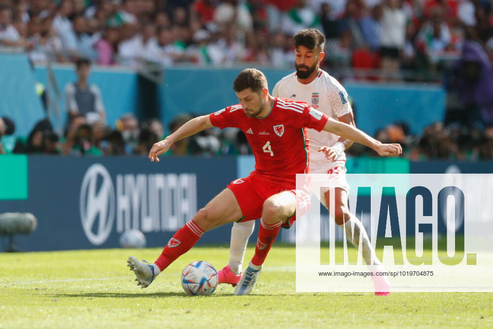 Wales v Iran 2022 FIFA World Cup, WM, Weltmeisterschaft, Fussball Ben Davies of Wales holds the ball up from Ramin Rezaeian of Iran during the 2022 FIFA World Cup Group B match at Ahmad Bin Ali Stadium, Al-Rayyan Content Not Available For UK Newspapers