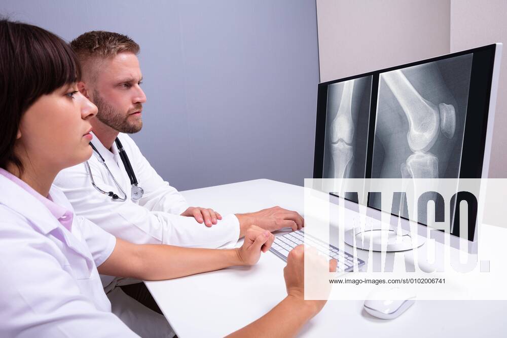 Doctors Examining Knee X-ray