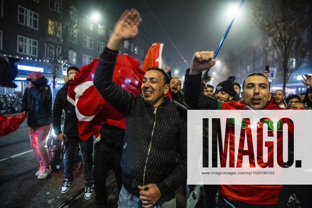 AMSTERDAM - Moroccan football supporters celebrate the 1-0 win of the Moroccan football team on the Mercatorplein in Amsterdam during the match between Morocco and Portugal at the World Cup in Qatar. ANP OLAF KRAAK netherlands out - belgium out Amsterdam IVx