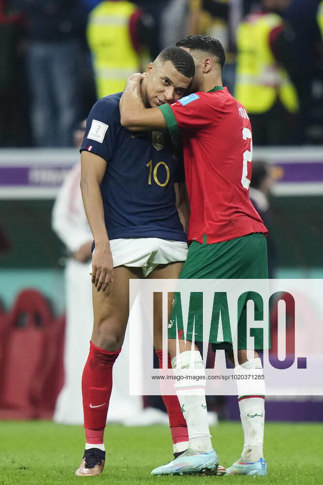 France v Morocco: Semi Final - FIFA World Cup, WM, Weltmeisterschaft, Fussball Qatar 2022 Kylian Mbappe centre-forward of France and Paris Saint-Germain and Achraf Hakimi right-back of Morocco and Paris Saint-Germain greet each other after the FIFA World Cup Qatar 2022 semi final match between France and Morocco at Al Bayt Stadium on December 14, 2022 in Al Khor, Qatar. Al Khor Qatar