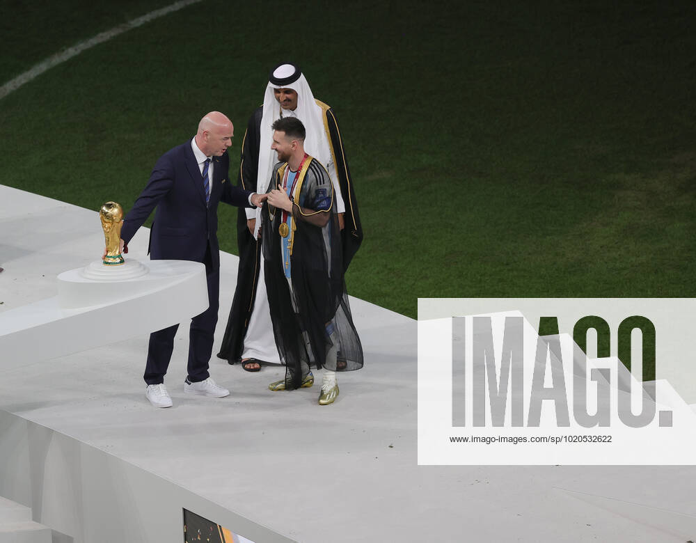 Argentina v France 2022 FIFA World Cup, WM, Weltmeisterschaft, Fussball Emir of Qatar, Tamim bin Hamad Al Thani, FIFA President Gianni Infantino and Lionel Messi of Argentina with the World Cup trophy during the 2022 FIFA World Cup Final between Argentina and France at Lusail Stadium, Lusail Content Not Available For UK Newspapers