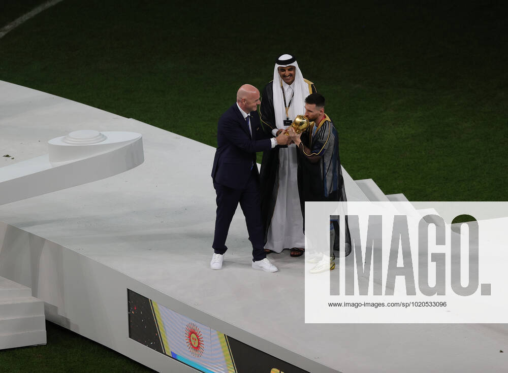 Argentina v France 2022 FIFA World Cup, WM, Weltmeisterschaft, Fussball Emir of Qatar, Tamim bin Hamad Al Thani, FIFA President Gianni Infantino and Lionel Messi of Argentina with the World Cup trophy during the 2022 FIFA World Cup Final between Argentina and France at Lusail Stadium, Lusail Content Not Available For UK Newspapers