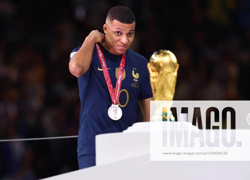 Doha, Qatar, 18th December 2022. Kylan Mbappe of France glance at the World Cup as he collects his looters medal during the FIFA World Cup, WM, Weltmeisterschaft, Fussball 2022 match at Lusail Stadium, Doha. Picture credit should read: David Klein Sportimage . SPI-2101-0214