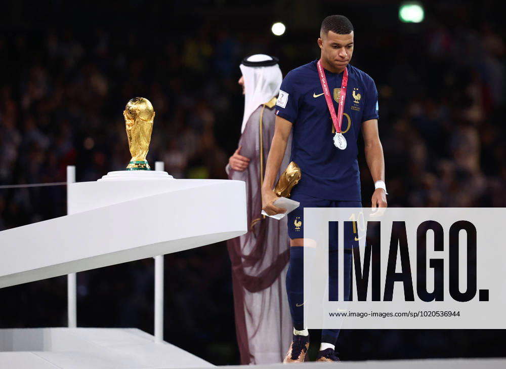 Doha, Qatar, 18th December 2022. Kylan Mbappe of France walks past the World Cup as he collects his Golden Boot award during the FIFA World Cup, WM, Weltmeisterschaft, Fussball 2022 match at Lusail Stadium, Doha. Picture credit should read: David Klein Sportimage . SPI-2101-0235