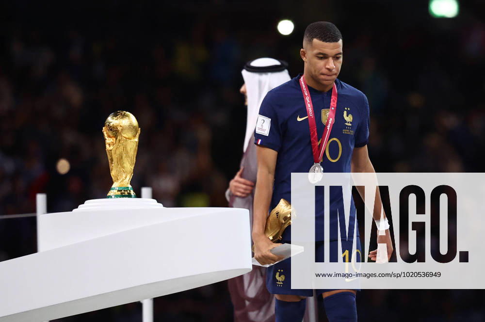 Doha, Qatar, 18th December 2022. Kylan Mbappe of France walks past the World Cup as he collects his Golden Boot award during the FIFA World Cup, WM, Weltmeisterschaft, Fussball 2022 match at Lusail Stadium, Doha. Picture credit should read: David Klein Sportimage . SPI-2101-0236
