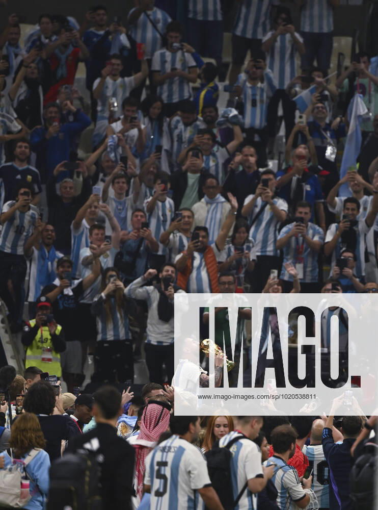 (221218) -- LUSAIER, Dec. 18, 2022 -- Lionel Messi of Argentina celebrates with the trophy in front of the fans after winning the Final between Argentina and France at the 2022 FIFA World Cup, WM, Weltmeisterschaft, Fussball at Lusail Stadium in Lusail, Qatar, Dec. 18, 2022. ) (SP)QATAR-LUSAIL-2022 WORLD CUP-FINAL-ARG VS FRA LixGa