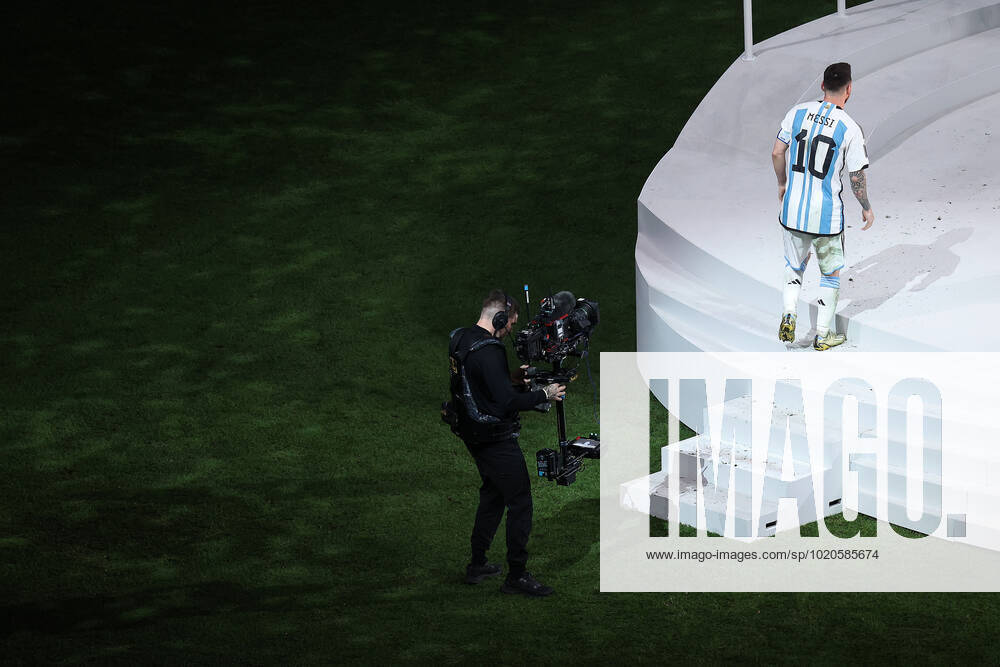The Final : FIFA World Cup, WM, Weltmeisterschaft, Fussball 18 December 2022, Lusail City - FIFA World Cup Qatar 2022 - Final - Argentina v France - Lionel Messi of Argentina is filmed as he walks up the stairs of the stage to collect the trophy - Photo: Charlotte Wilson Offside. Doha Qatar