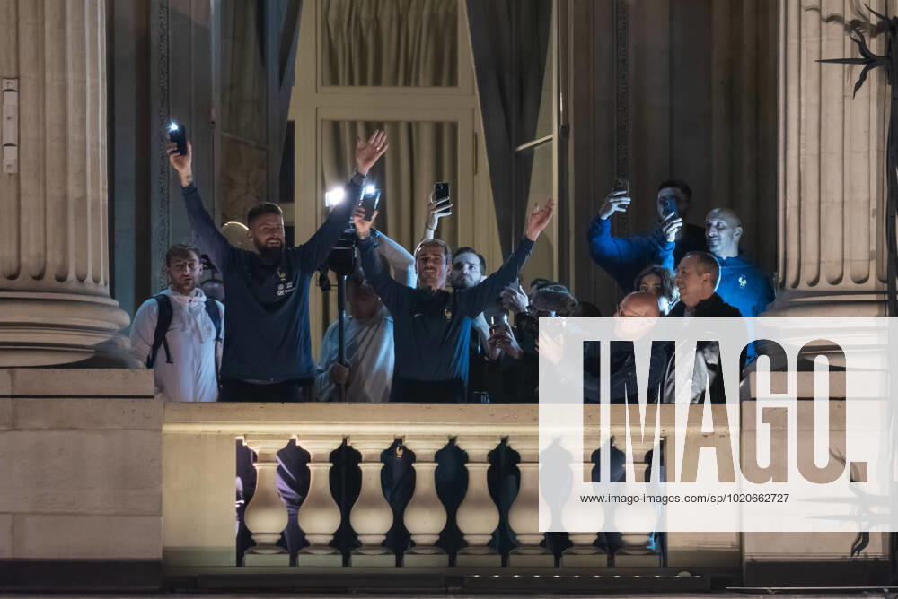 KW51 French Football Team Fans Greet The Players On The Place De La Concorde In Paris French football team players Antoine Griezman and Olivier Giroud wave to the crowd as French football team supporters gather on the Place de la Concorde with French flags to welcome the players on the balcony of the Hotel de Crillon after their return from Qatar following their defeat against Argentina in the World Cup final in Paris on December 19, 2022. Paris France