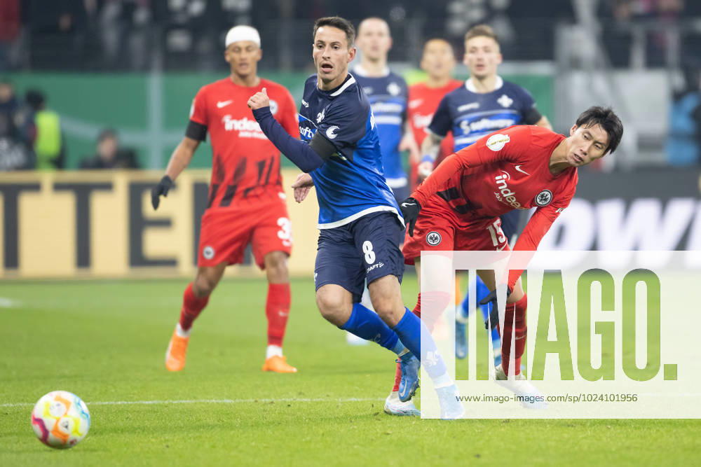 Eintracht Frankfurt - SV Darmstadt 98, DFB-Pokal Fabian Schnellhardt (Darmstadt, 8) gegen Daichi Kamada (Eintracht Frankfurt, 15). DFB-Pokalspiel zwischen Eintracht Frankfurt und dem SV Darmstadt 98 am 7. Februar 2023 im Deutsche Bank Park in Frankfurt am Main. Nach Vorgaben der DFL, Deutsche Fußball Liga, ist es untersagt, in dem Stadion und oder vom Spiel angefertigte Fotoaufnahmen in Form von Sequenzbildern und oder videoähnlichen Fotostrecken zu verwerten bzw. verwerten zu lassen., Frankfurt am Main Hessen Deutschland Deutsche Bank Park