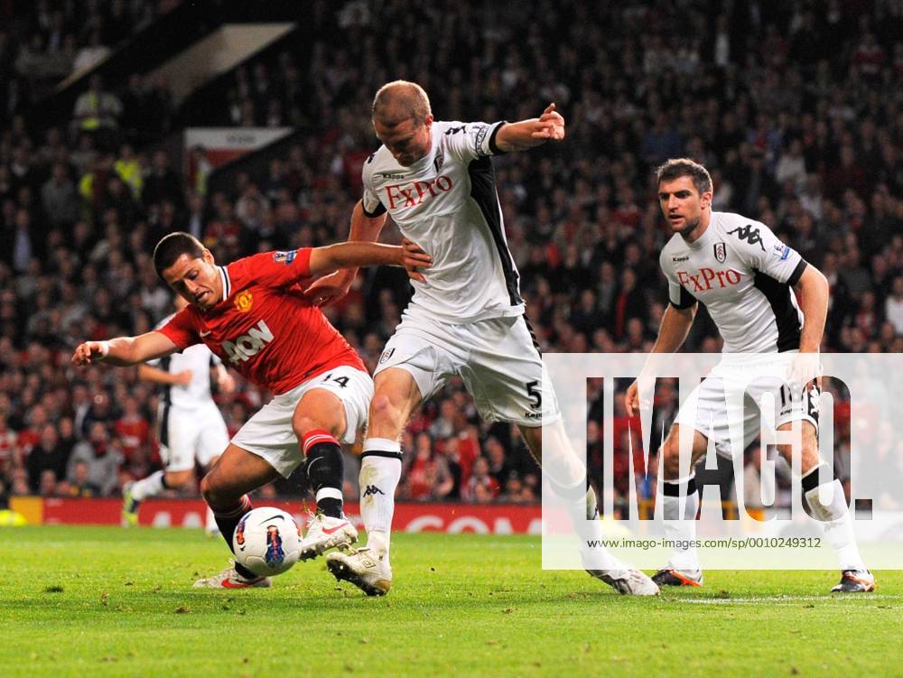 Javier Hernandez (Chicharito) of Manchester United tackled by Brede Hangeland of Fulham Barclays Premier League match between Manchester Utd v Fulham at Old Trafford Stadium, Manchester on the 26th March 2012 .