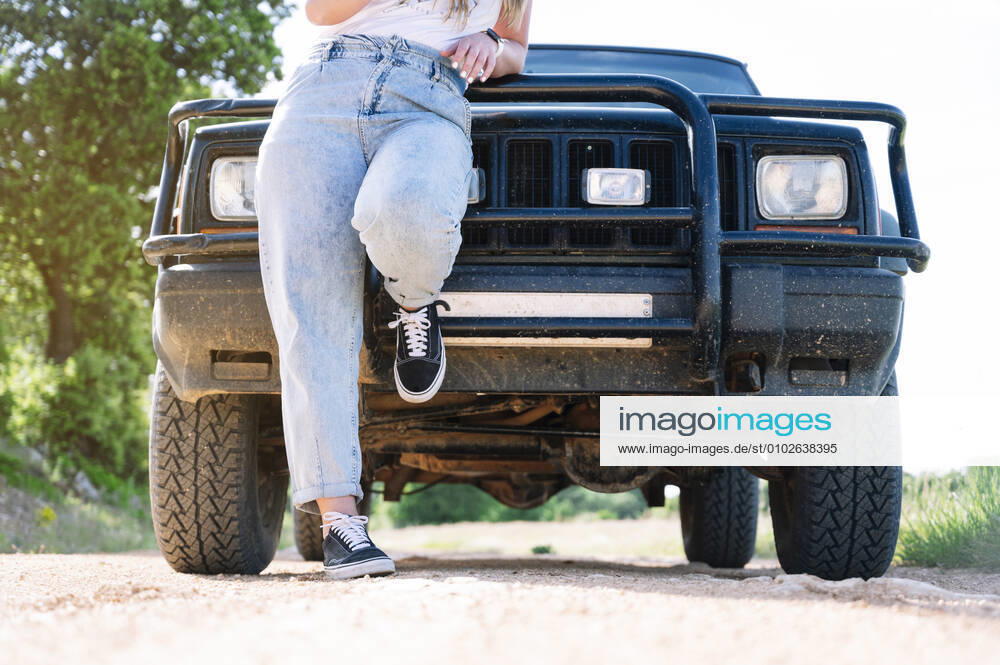 Woman leaning on vehicle hood during road trip model released Symbolfoto JCMF00896