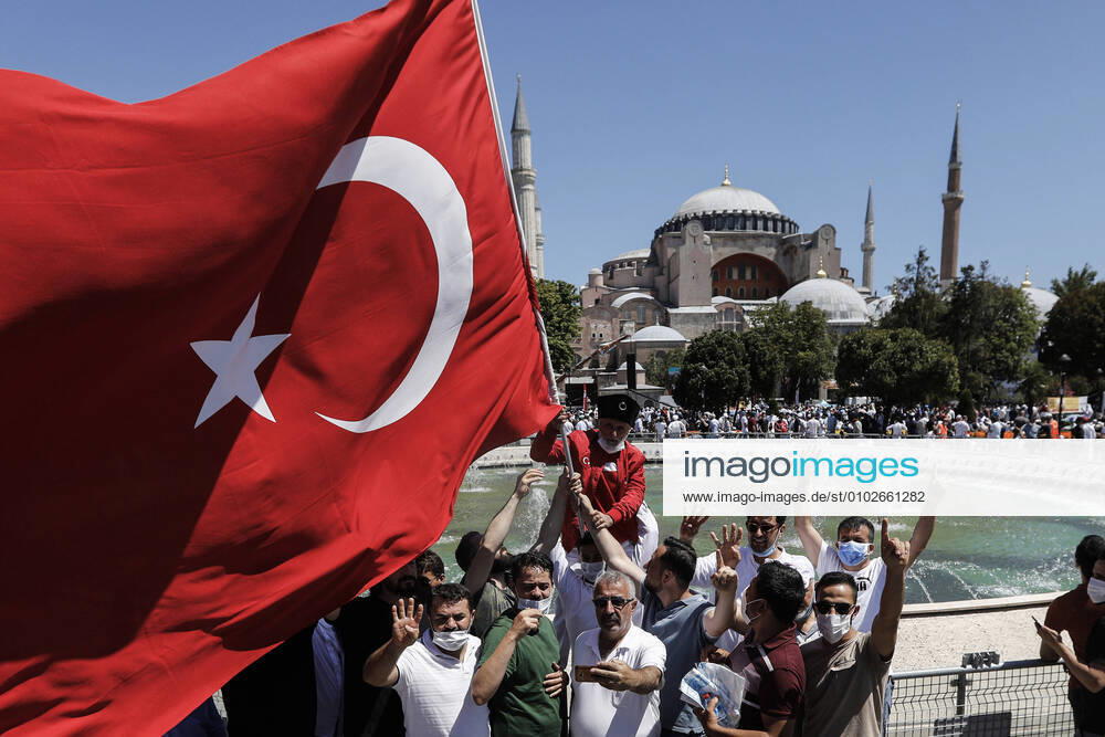 People hold Turkish flag and celebrating Hagia Sophiaâ€⠢s reconversion at outside of the Hagia Sophia Mosque. Istanbul Turkey - ZUMAz112 20200724_zip_z112_056