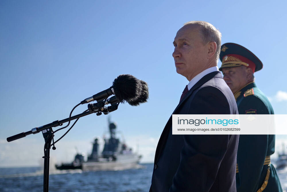 Russia s President Vladimir Putin (L) and Russia s Defense Minister Sergei Shoigu inspect warships in the Kronstadt roadstead aboard the Raptor boat ahead of a military parade on Russian Navy Day. Alexei Druzhinin Russian Presidential Press and Information Office TASS TS0E1408