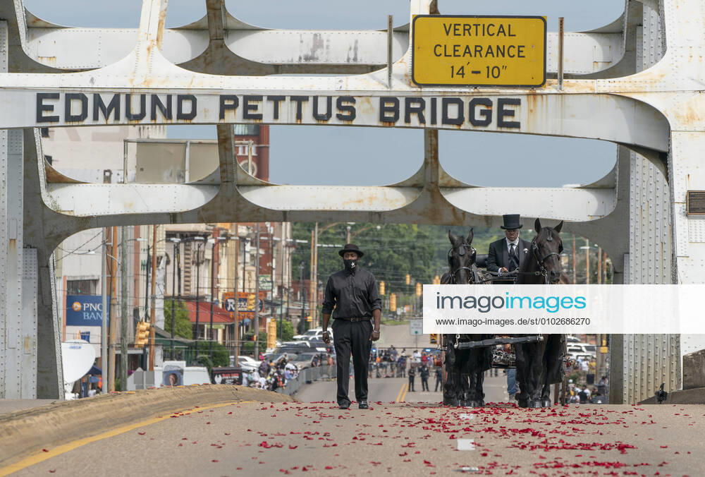 KW30 The casket containing the body of Congressman John Lewis, D-GA, crosses the Edmund Pettus Bridge during his funeral procession in Selma, Alabama on Sunday, July 26, 2020. In 1965 at the age of 25, Lewis helped to organize a march for voting rights on the Edmund Pettus Bridge, where his skull was fractured after being attacked by police. Lewis died on July 17 at the age of 80 after a six-month battle with cancer. ALB20200726304 JEMALxCOUNTLESS