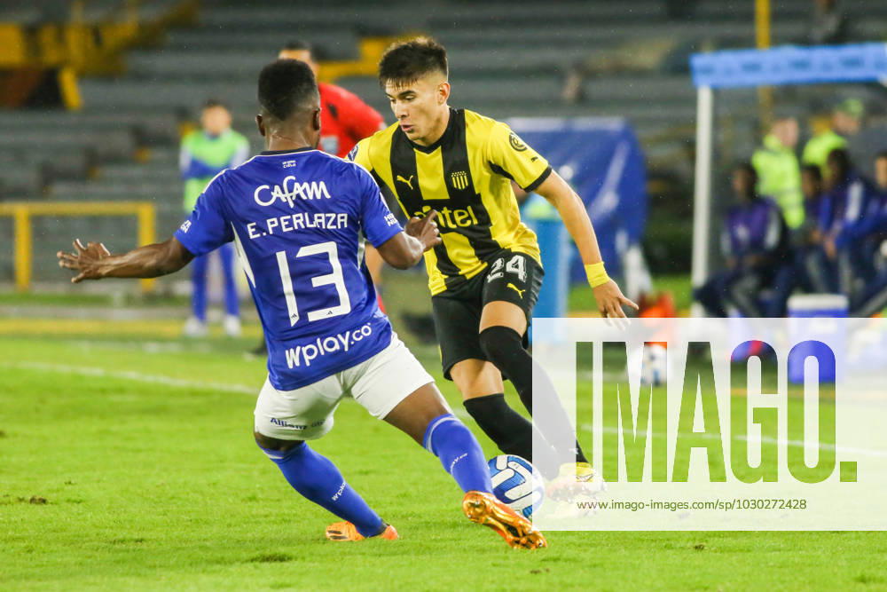 Elvis Perlaza of Millonarios and Brian Mansilla of Penarol fight for the ball in the match between Millonarios FC vs CA Penarol of Uruguay for CONMEBOL Sudamericana date 4 played at the Nemesio Camacho El Campin stadium in the city of Bogota, Colombia. Bogota Colombia - ZUMAh147 0257688938st