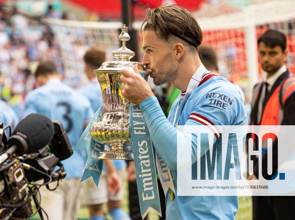 Football - FA Cup - Final - Manchester City FC v Manchester United, ManU FC LONDON, ENGLAND - Saturday, June 3, 2023: Manchester City s Jack Grealish celebrates as he kisses the trophy after the FA Cup Final between Manchester City FC and Manchester United FC at Wembley Stadium. Man City won 2-1. LONDON Wembley Stadium GREATER LONDON ENGLAND