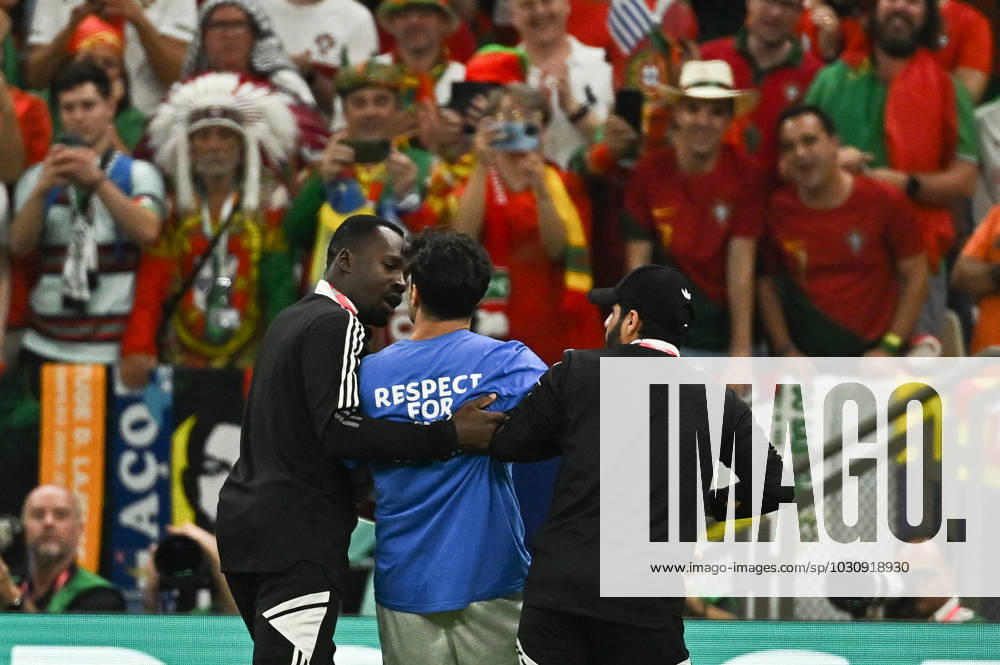 World Cup - A man with an LGBT flag during Portugal - Uruguay - Qatar A man carrying a rainbow flag and wearing a T-shirt in support of Iranian women ran into the pitch during Portugal v Uruguay match of the FIFA World Cup, WM, Weltmeisterschaft, Fussball Qatar 2022 Al Lusail Stadium in Doha, Qatar on November 28, 2022. Photo by Laurent Zabulon ABACAPRESS.COM Doha Qatar