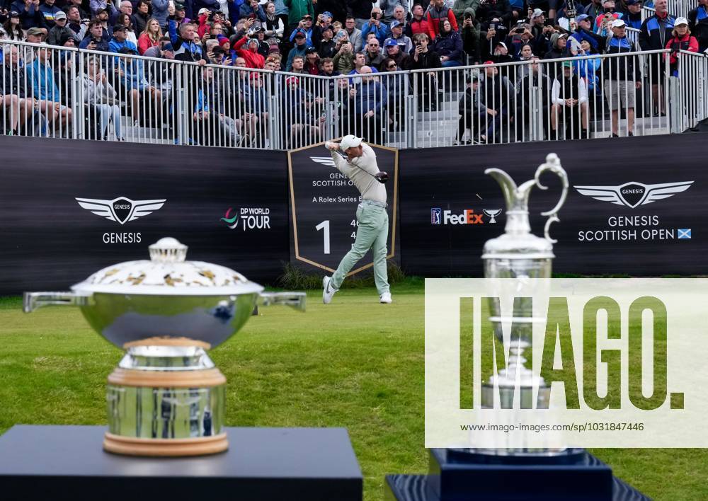 Mandatory Credit: Photo by Stuart Wallace Shutterstock (14003901f) Rory McIlroy (NIR) plays his tee shot on the 1st hole during the final round, flanked by the Genesis Scottish Open trophy and the Claret Jug. Genesis Scottish Open, Day Four, Golf, The Renaissance Club, North Berwick, UK - 16 Jul 2023 Genesis Scottish Open, Day Four, Golf, The Renaissance Club, North Berwick, UK - 16 Jul 2023