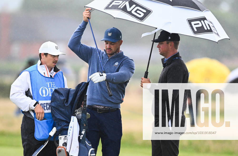 Mandatory Credit: Photo by Greig Cowie Shutterstock (14012011da) Bryson DeChambeau on the 16th fairway shelters from the rain The British Open Championship, Practice, Golf, Royal Liverpool Golf Club, Liverpool, UK - 17 Jul 2023 The British Open Championship, Practice, Golf, Royal Liverpool Golf Club, Liverpool, UK - 17 Jul 2023