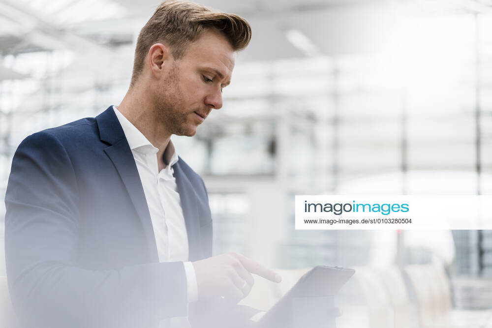 Male entrepreneur using digital tablet while sitting in city model released Symbolfoto DIGF12857