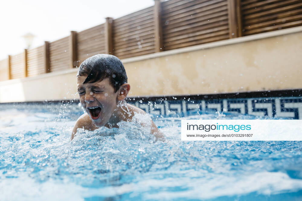 Boy enjoying in swimming pool during summer model released Symbolfoto property released JRFF04689