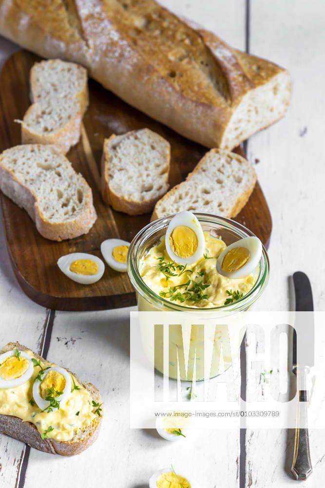 Sliced baguette and jar of homemade egg salad with cress SARF04610