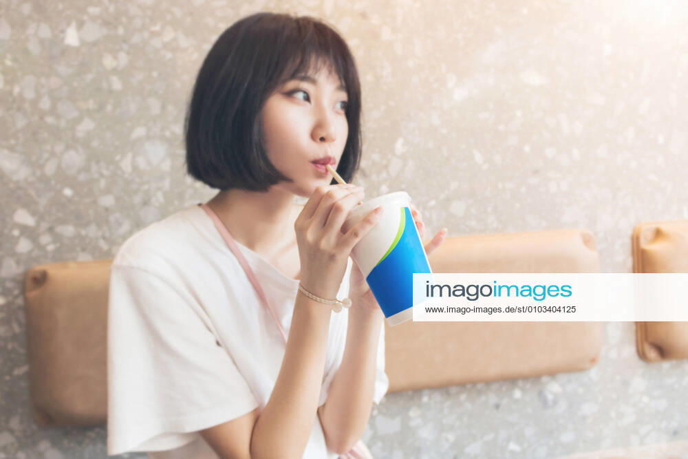 Happy girl drinking coke in the restaurant. 644077702409879562 ,model released, Symbolfoto