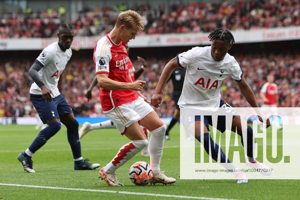London, England, 24th September 2023. Martin Odegaard of Arsenal (left) and Destiny Udogie of Tottenham Hotspur (right) battle for the ball during the Premier League match at the Emirates Stadium, London. Picture credit should read: Kieran Cleeves Sportimage . SPI-2594-0119