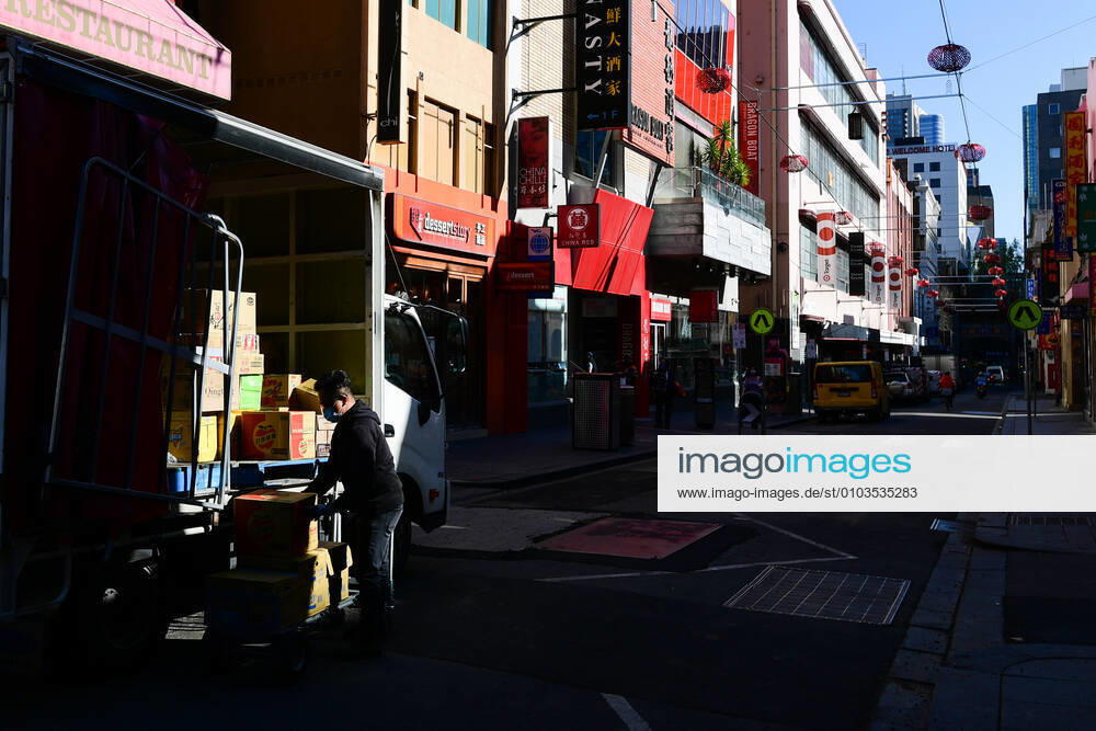 VICTORIA CORONAVIRUS COVID19, A delivery driver unpacks boxes on Little Bourke Street in Melbourne, Friday, August 28, 2020. Stage four coronavirus restrictions are in force across metropolitan Melbourne including a 8pm to 5am curfew, people must remain within a 5km radius of their homes and an hourly limit on exercise has been introduced. ( NO ARCHIVING, , NO USE IN BOOKS WITHOUT CONSENT MELBOURNE VIC AUSTRALIA