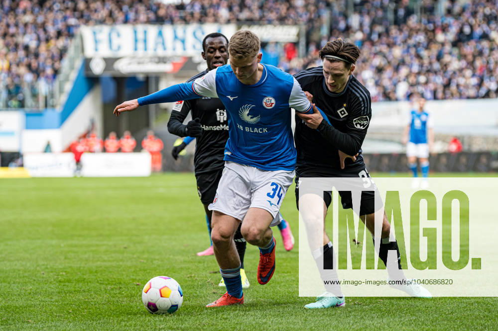 Rostock, Deutschland 17. Februar 2024: 2. BL - 2023 2024 - FC Hansa Rostock vs. Hamburger SV Im Bild: v. li. im Zweikampf Jannis Lang (Hansa Rostock) und Noah Katterbach (Hamburger SV) DFL regulations prohibit any use of photographs as image sequences and or quasi-video.