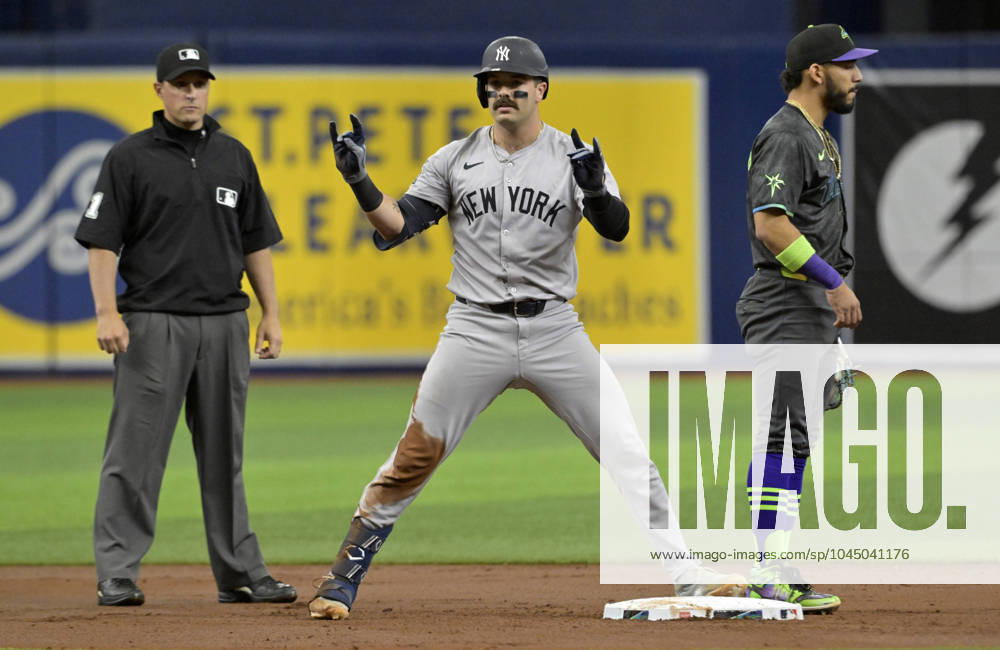 New York Yankees Austin Wells celebrates between umpire Quinn Wolcott (81) and Tampa Bay Rays José Caballero after hitting a double during the second inning of a baseball game at Tropicana Field in St. Petersburg, Florida on Saturday, May 11, 2024. FLSN20240511107 STEVExNESIUS
