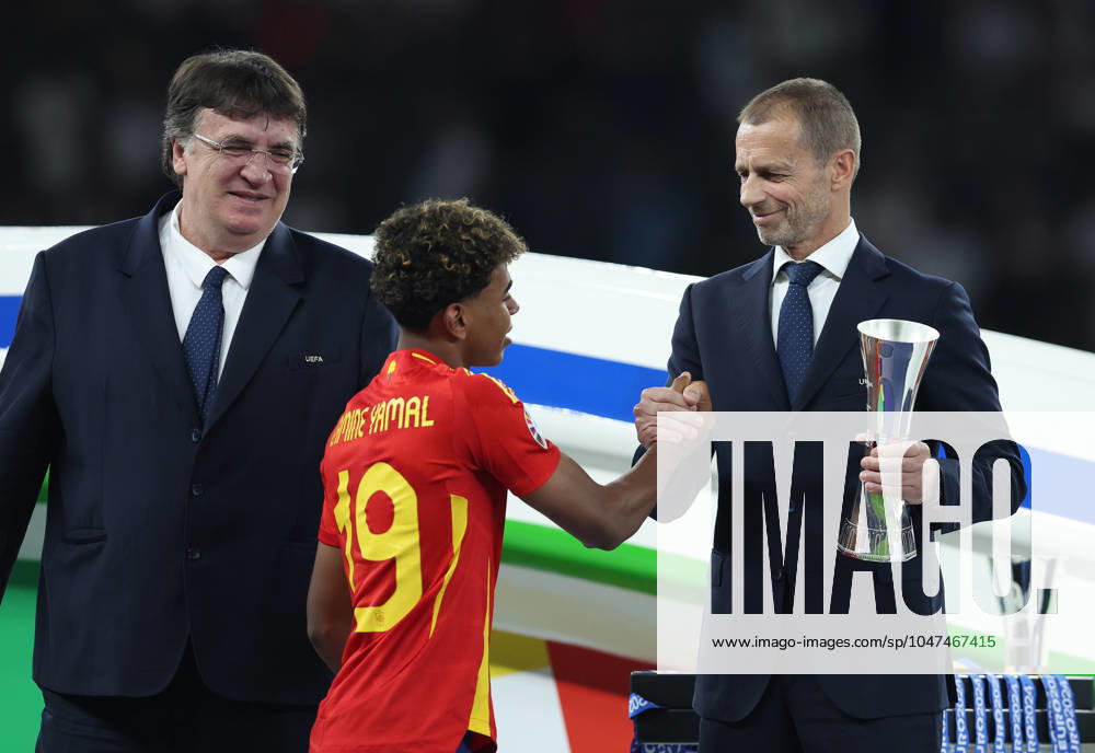 Berlin, Germany, 14th July 2024. Lamine Yamal of Spain shakes hands with Aleksander Ceferin, President of UEFA as he collects his young player of the tournament trophy during the UEFA European Championships final match at Olympiastadion, Berlin. Picture: Paul Terry Sportimage . SPI-3227-0323