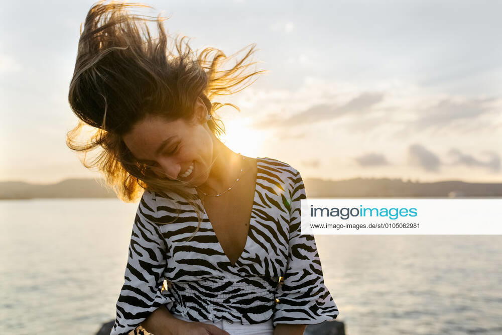 Beautiful woman tossing hair against clear sky model released Symbolfoto MGOF04389