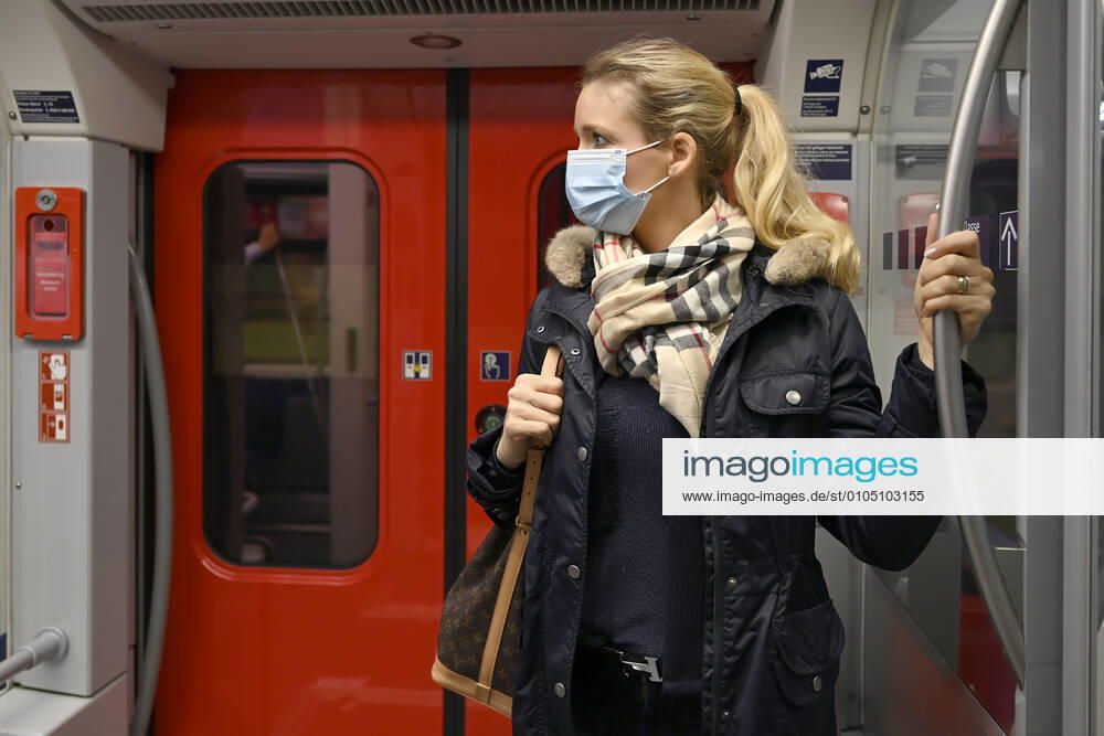 Frau mit Mundschutzmaske, steht in S-Bahn, Corona-Krise, Stuttgart, Baden-Württemberg, Deutschland Coronavirus