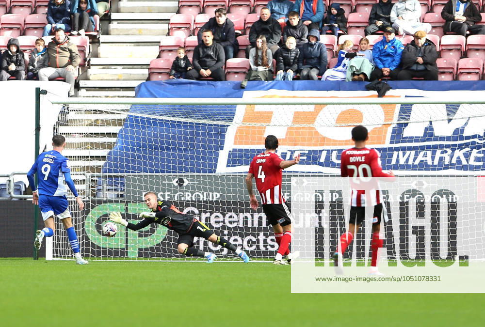 Wigan Athletic v Exeter City EFL Sky Bet League 1 28 09 2024. Exeter City goalkeeper Joe Whitworth (1) saves a shot from Wigan Athletic midfielder Dion Rankine (7) during the EFL Sky Bet League 1 match between Wigan Athletic and Exeter City at the Brick Community Stadium, Wigan, England on 28 September 2024. Wigan Brick Community Stadium Greater Manchester England Editorial use only DataCo restrictions apply See www.football-dataco.com ,