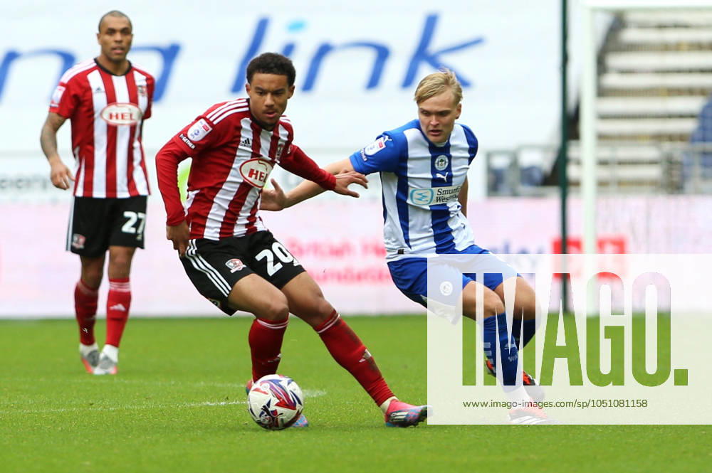 Wigan Athletic v Exeter City EFL Sky Bet League 1 28 09 2024. Exeter City midfielder Kamari Doyle (20) and Wigan Athletic midfielder Matt Smith (8) battle for possesion during the EFL Sky Bet League 1 match between Wigan Athletic and Exeter City at the Brick Community Stadium, Wigan, England on 28 September 2024. Wigan Brick Community Stadium Greater Manchester England Editorial use only DataCo restrictions apply See www.football-dataco.com ,