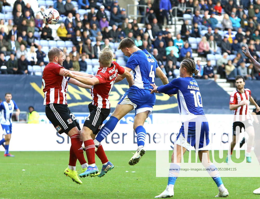 Wigan Athletic v Exeter City EFL Sky Bet League 1 28 09 2024. Wigan Athletic defender Will Aimson (4) heads at goal late on but sees his header saved during the EFL Sky Bet League 1 match between Wigan Athletic and Exeter City at the Brick Community Stadium, Wigan, England on 28 September 2024. Wigan Brick Community Stadium Greater Manchester England Editorial use only DataCo restrictions apply See www.football-dataco.com ,