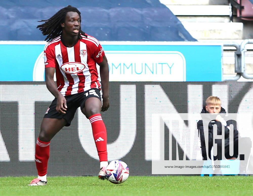 Wigan Athletic v Exeter City EFL Sky Bet League 1 28 09 2024. Exeter City defender Johnly Yfeko (15) ith ball during the EFL Sky Bet League 1 match between Wigan Athletic and Exeter City at the Brick Community Stadium, Wigan, England on 28 September 2024. Wigan Brick Community Stadium Greater Manchester England Editorial use only DataCo restrictions apply See www.football-dataco.com ,