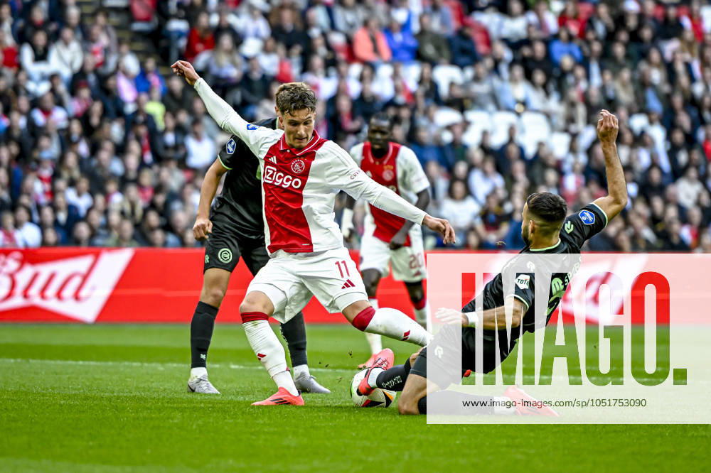 AFC Ajax Amsterdam forwarder Mika Godts, FC Groningen defender Marco Rente, during the match Ajax - Groningen at the Johan Cruijff ArenA for the Dutch eredivisie season 2024-2025 in AMSTERDAM, Netherlands on 6 oktober 2024, (photo by Stefan Koops EYE4images DeFodi Images) Defodi-746_193554