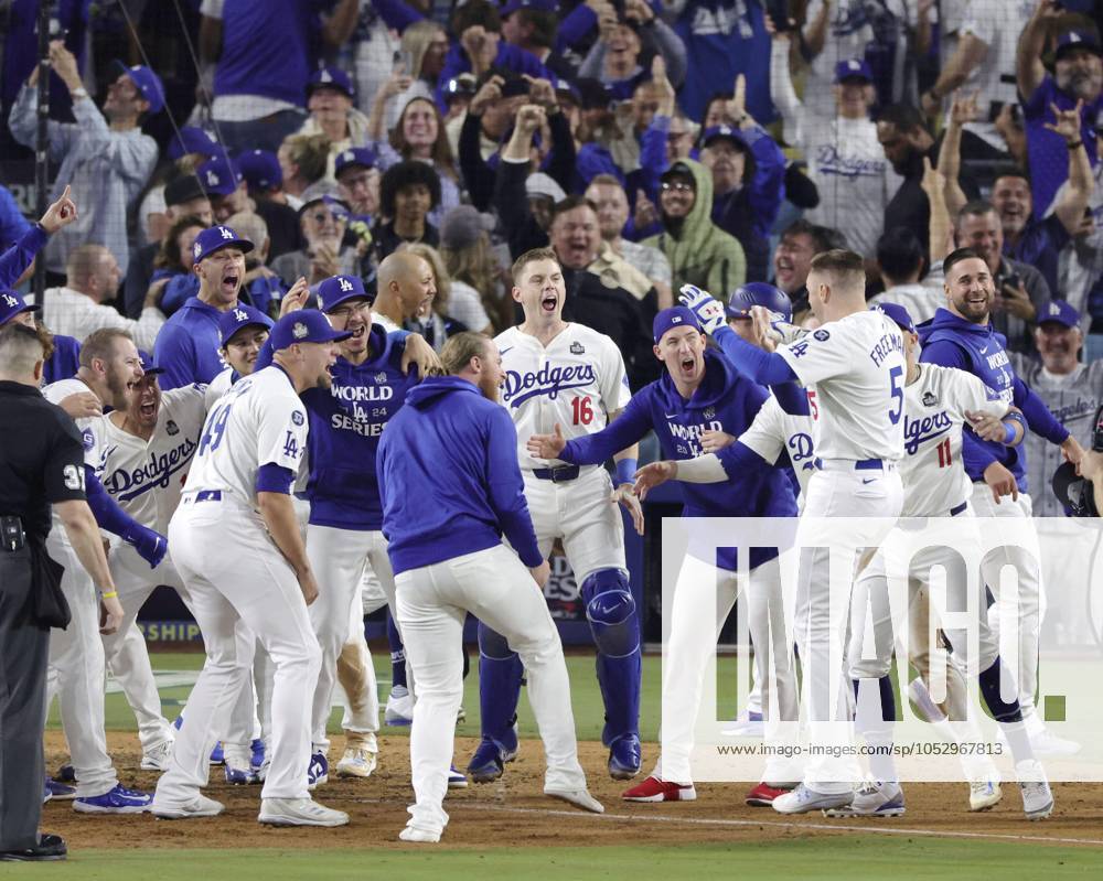 Baseball: World Series Freddie Freeman (5) of the Los Angeles Dodgers is congratulated by teammates after hitting a walk-off grand slam in the 10th inning of Game 1 of the World Series against the New York Yankees at Dodger Stadium in Los Angeles on Oct. 25, 2024. A14AA0003639776P