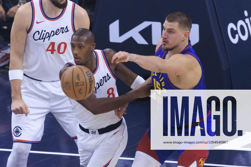Nikola Jokic 15 of the Denver Nuggets passes the ball as Kris Dunn 8 of the Los Angeles Clippers defends during their regular season NBA, Basketball Herren, USA game on Sunday December 1, 2024 at Intuit Dome in Inglewood, California. Clippers defeat Nuggets, 126-122. ARIANA RUIZ PI Inglewood U.S - ZUMAp124 20241201_zaa_p124_065