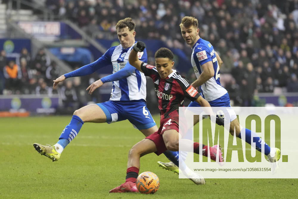 8th February 2025: Brick Community Stadium, Wigan, Greater Manchester, England; FA Cup Fourth Round Football, Wigan Athletic versus Fulham; Joshua King of Fulham shoots at goal under pressure from Jensen Weir of Wigan Athletic ActionPlus12748665 StevenxFlynn