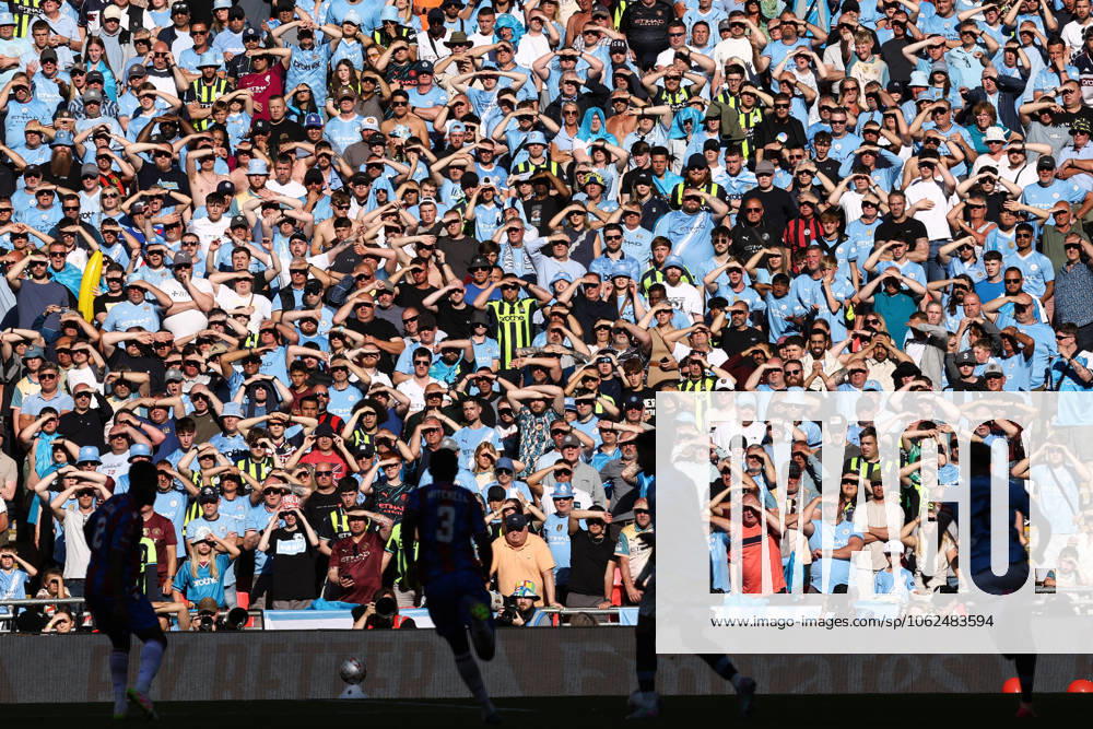 Crystal Palace v Manchester City 17 May 2025, London - FA Cup Final - Crystal Palace v Manchester City - City fans shield their eyes from the sun - Photo: Jacques Feeney Offside. London UK