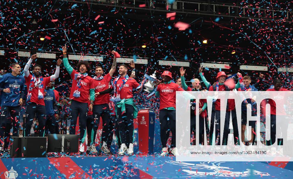 . - Crystal Palace FA Cup Trophy Parade & Celebrations, Selhurst Park Stadium, London, England. - 26th May 2025. (C) Daniel Weir Crystal Pix Joel Ward of Crystal Palace & Marc Guehi of Crystal Palace hold aloft the Emirates FA Cup Trophy in celebration with there team mates on the stage at Selhurst Park under Confetti during the Crystal Palace FA Cup trophy bus parade & party celebrations at Selhurst Park stadium in South London. - Crystal Palace FA Cup Trophy Parade & Celebrations, Selhurst Park Stadium, London, England. - 26th May 2025. (C) Daniel Weir Crystal Pix London Selhurst Park Stadium United Kingdom